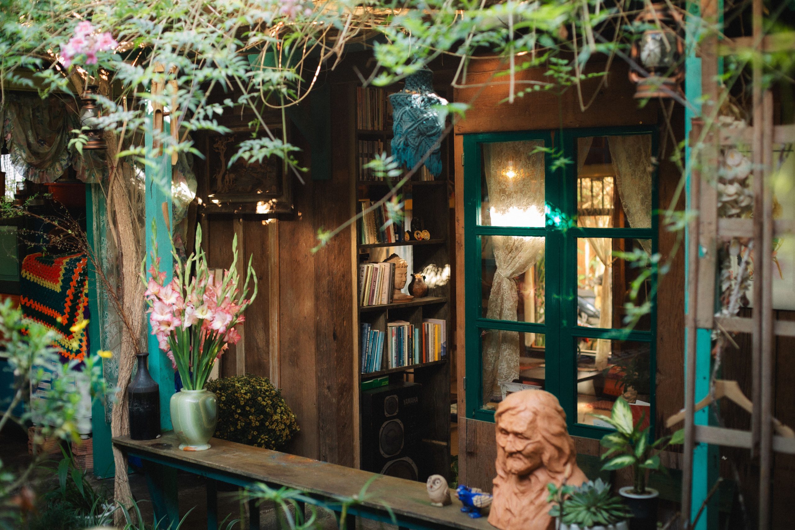Cozy outdoor garden library with rustic decor surrounded by natural greenery